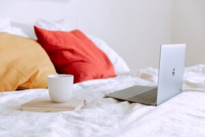 pexels-photo-3975585-3975585-1 Cozy hotel room with a bed, laptop, and couch, symbolizing brand visibility and digital engagement in hospitality.